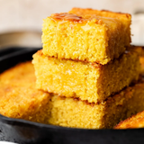 Stacked squares of honey-drizzled cornbread baked in the Lucky New Year cooking class at Culinary by Hobby Hill